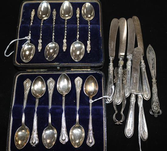 Six silver apostle teaspoons, another set of 12 teaspoons (both cased), 6 silver-handled butter knives and two other items